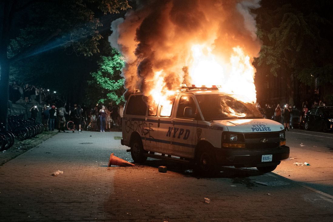 An NYPD van burns in Brooklyn.